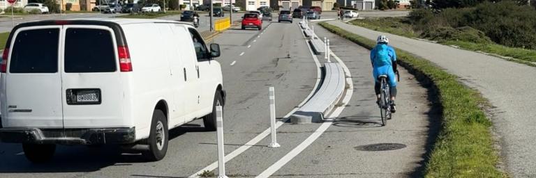 cyclist in completed bikeway on Lake Merced Blvd.