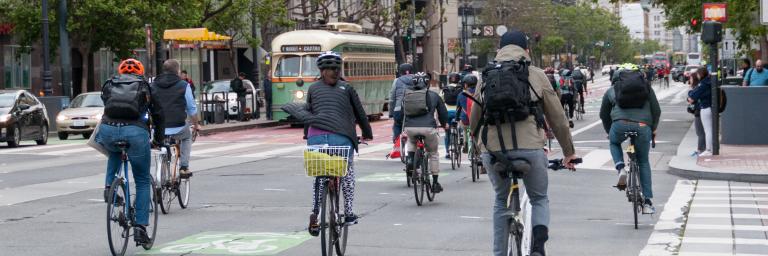 Bikers on Market Street with an F Market trolly