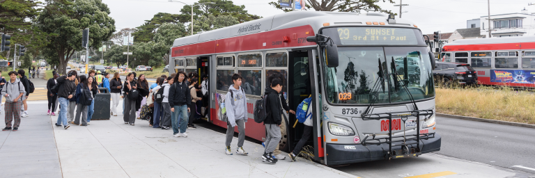 Students load onto 29 Sunset at a bus stop