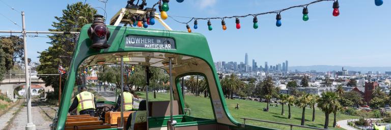 Boat Tram on the rails above Dolores Park with the view of Downtown beyond