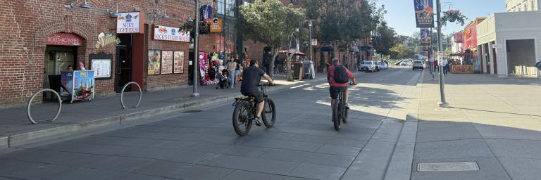 bicyclists heading west on Jefferson Street in front of the Cannery