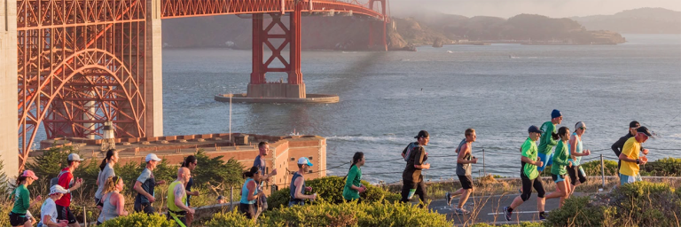Runners in the Headlands with the bridge behind