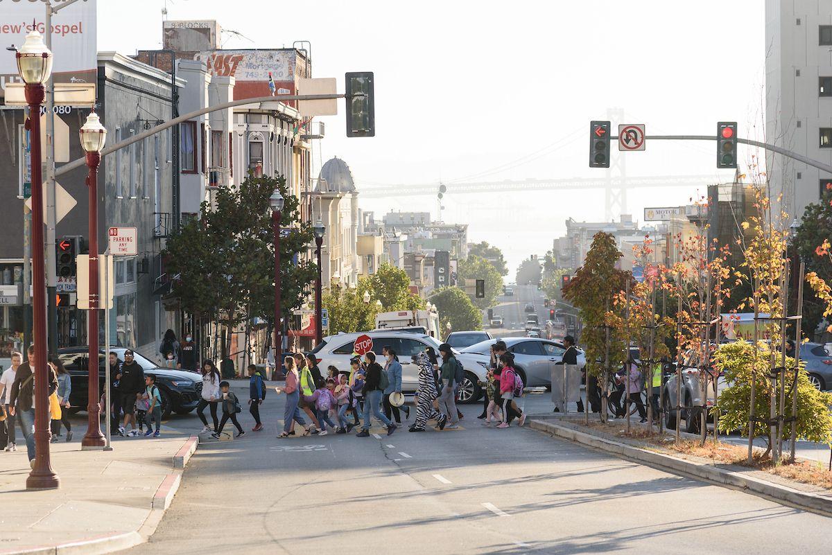 People and cars crossing a street