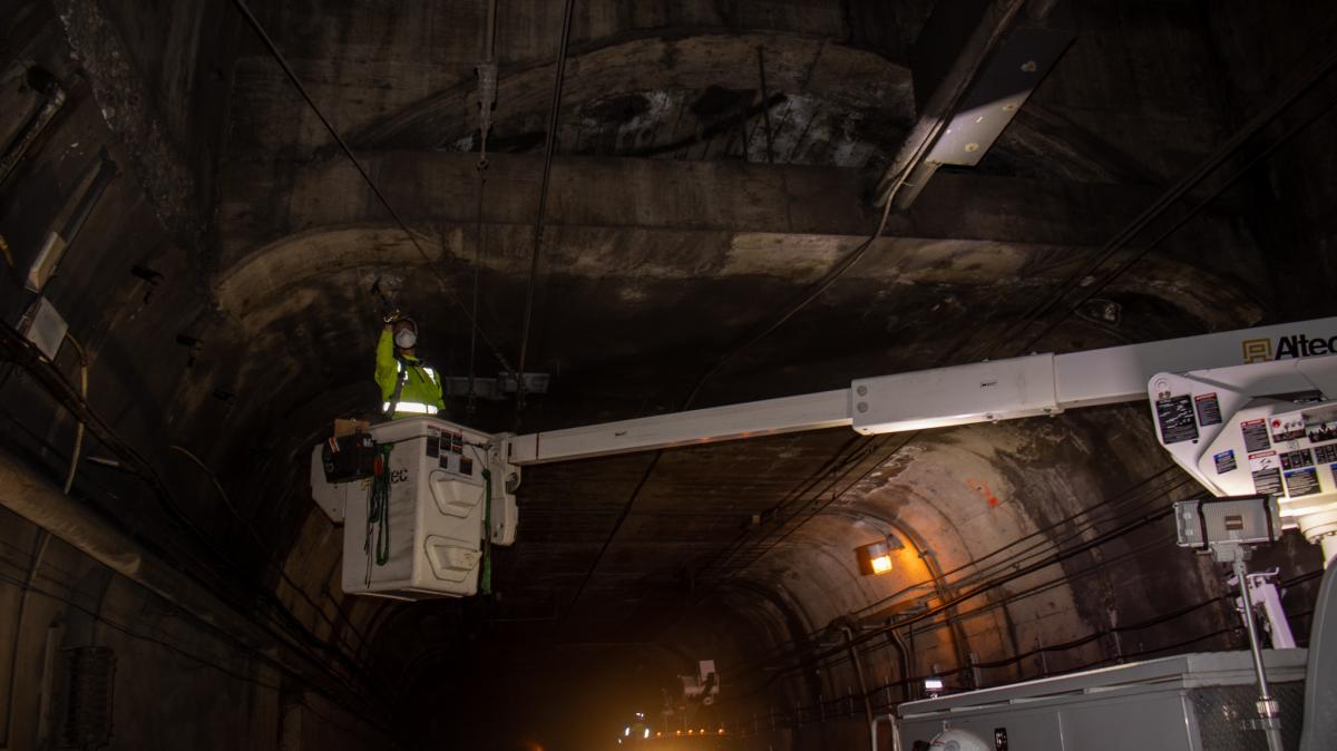 A worker inspects infrastructure in the Twin Peaks Tunnel