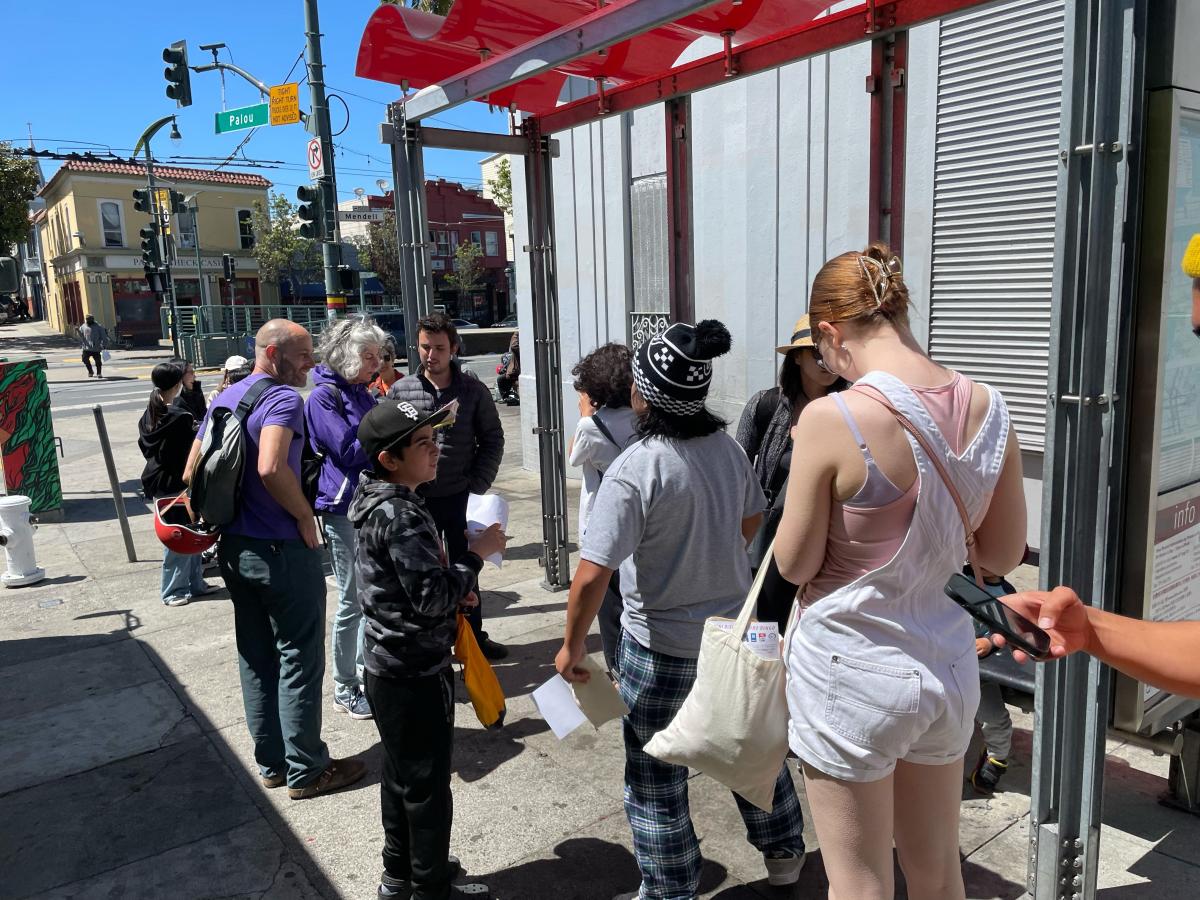 Several people wait at a bus stop. Several people wait at a bus stop.