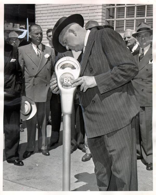 Mayor Roger D. Lapham tests a parking meter as a crowd looks on in San Francisco. Vintage photo from 1947. Mayor Roger D. Lapham tests a parking meter as a crowd looks on in San Francisco. Vintage photo from 1947.