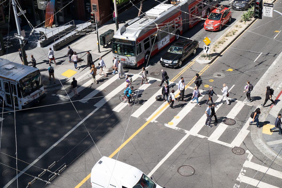 Aerial view of several people crossing a downtown San Francisco intersection. Aerial view of several people crossing a downtown San Francisco intersection.