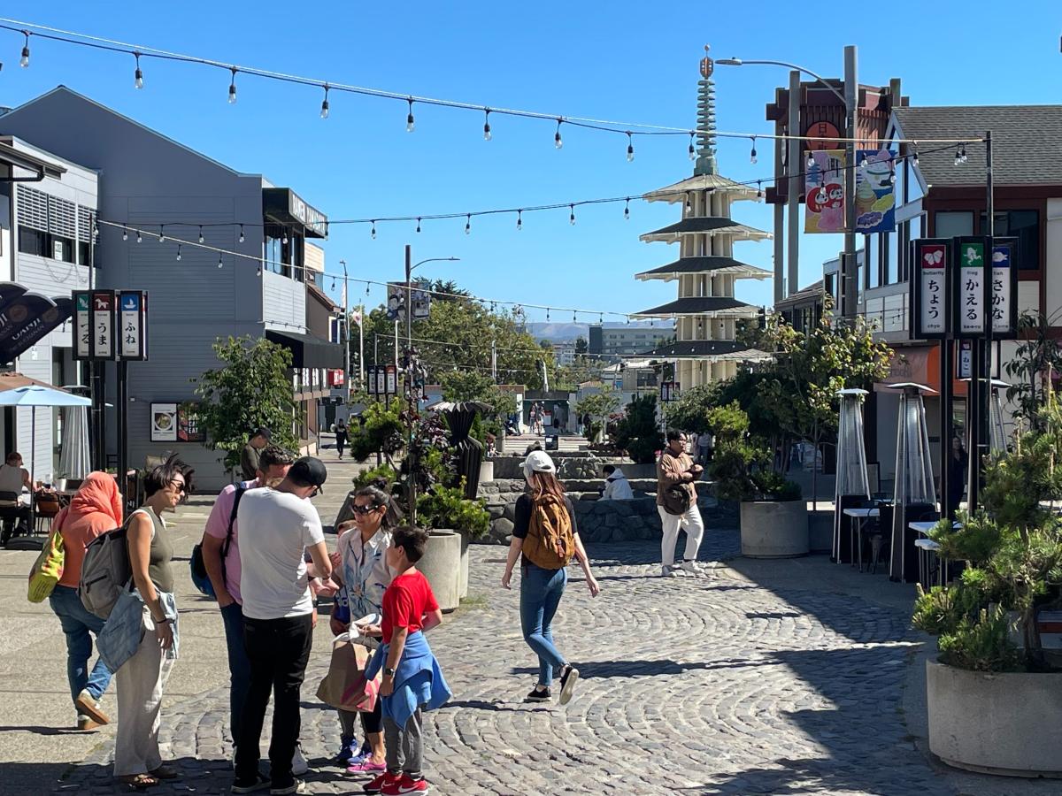 People stand and walk in a plaza in Japantown. People stand and walk in a plaza in Japantown.