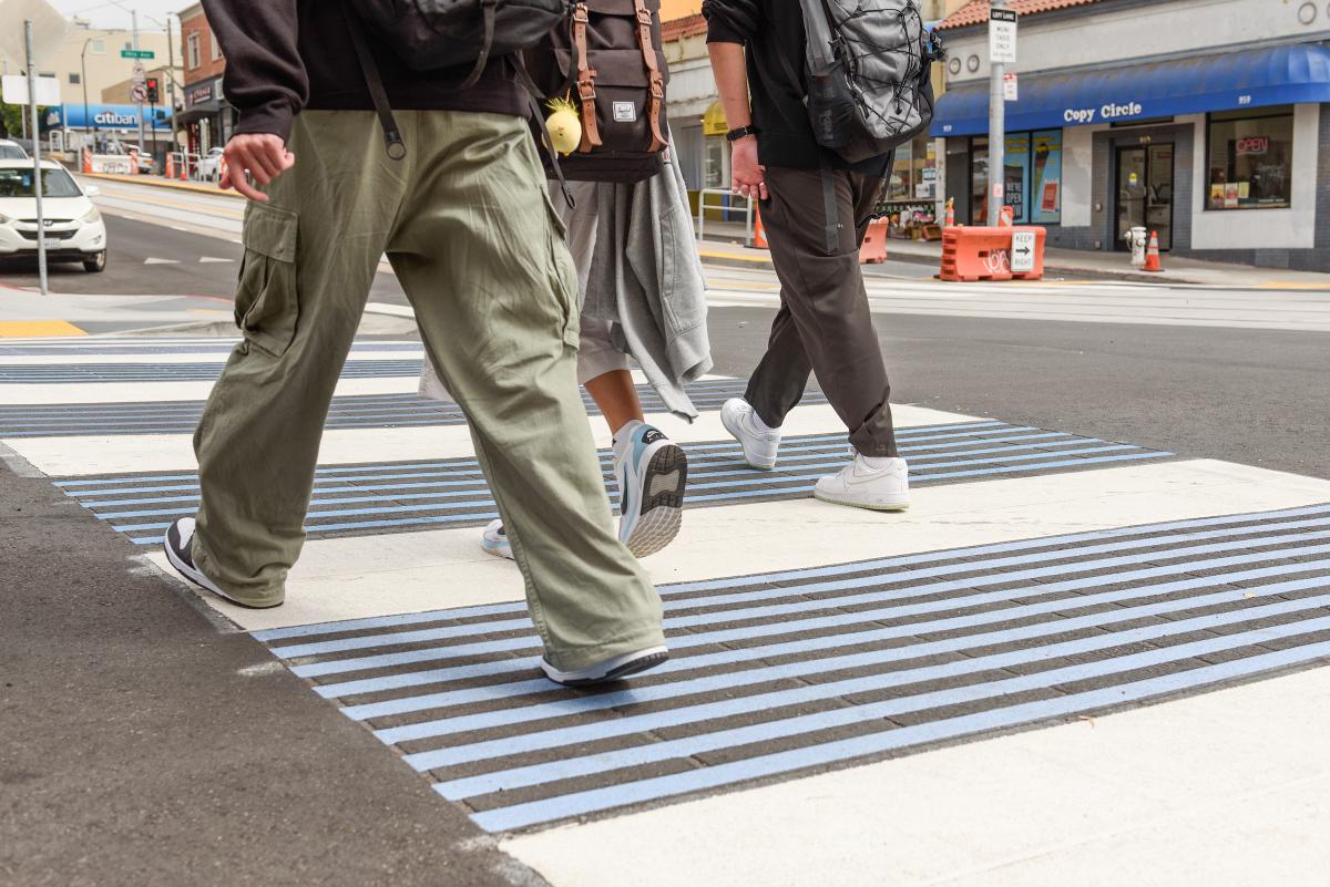 People crossing an intersection. People crossing an intersection.