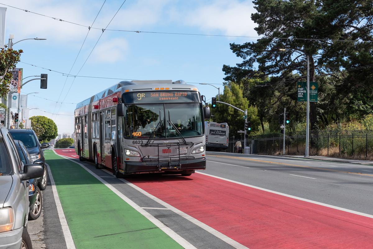 Image of the 9R San Bruno using a red transit-only lane that's beside a green lane for people biking.