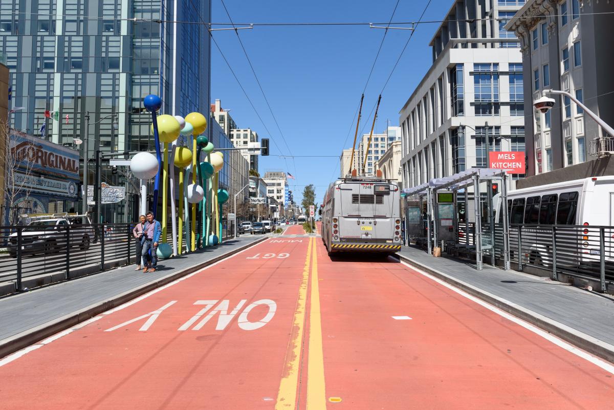 The 49 Van Ness bus drives on a red transit-only lane heading north.