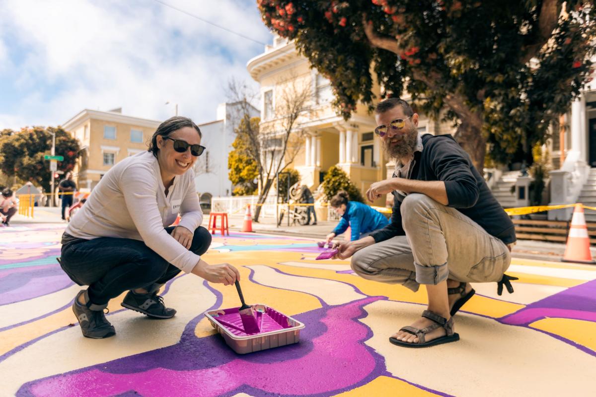 Image of people painting a street mural
