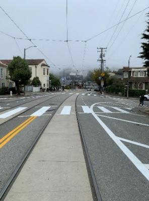West Portal - Ulloa Painted Lanes Small On Ulloa Street, the traffic lane is painted to be more narrow in advance of the crosswalk at Wawona Street