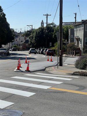 West Portal - Five-way concrete island small On Vicente Street, a new concrete island extends into the intersection at Wawona Street
