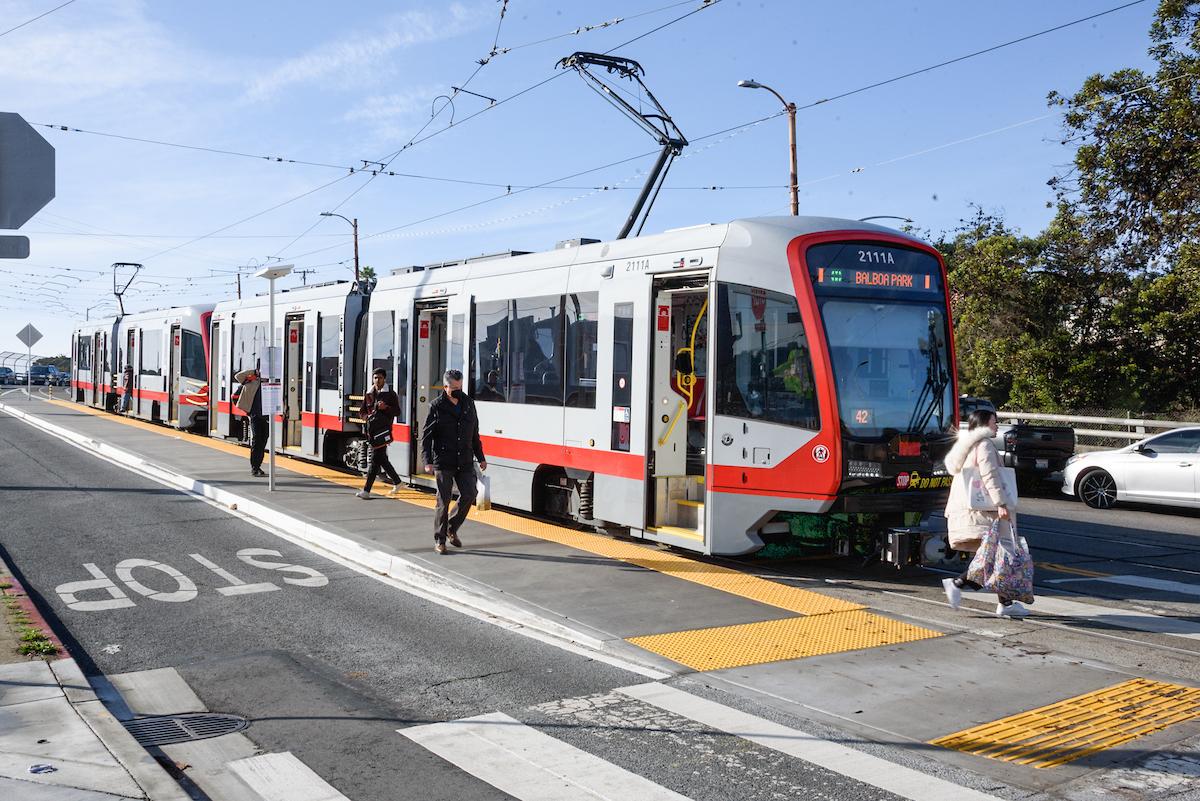 M Ocean View riders step off the train onto a new boarding island at its final outbound stop on San Jose and Niagara avenues.