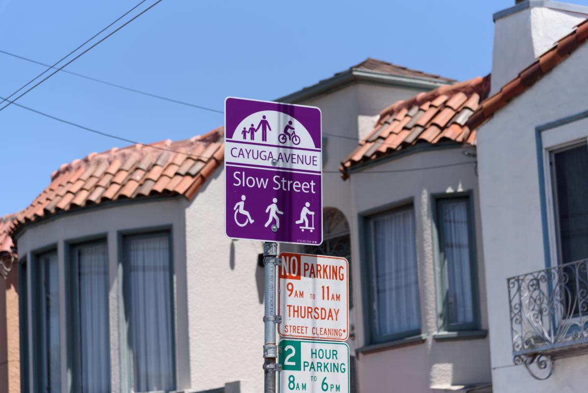 Photo of a purple Cayuga Slow Street sign