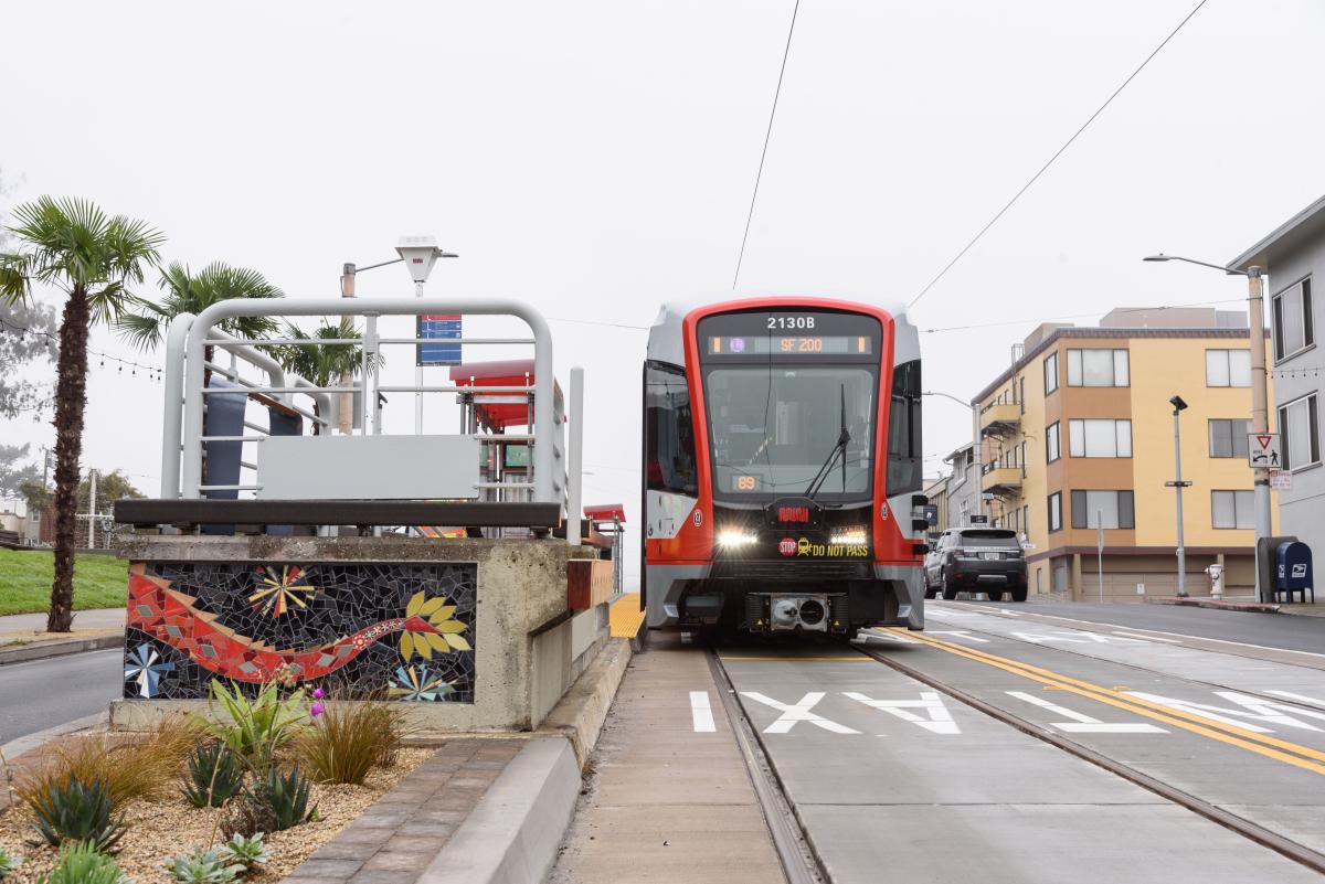 L Taraval train approaches an accessible platform.