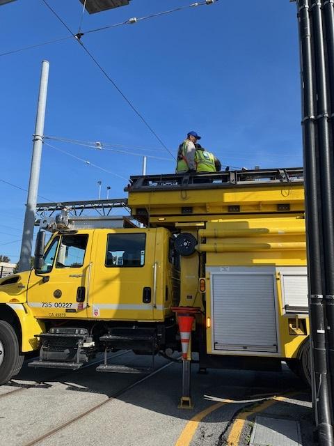 the SFMTA team working together at MME to install overhead lines