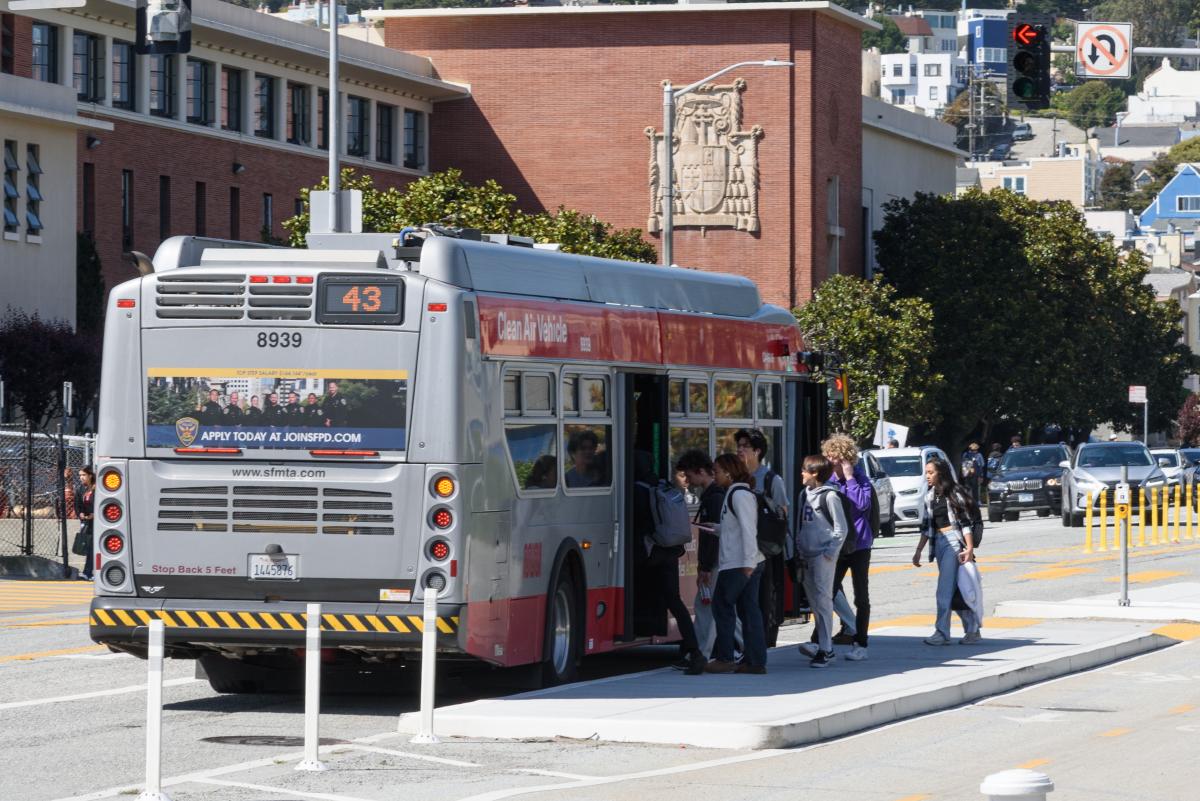 People getting on a bus.