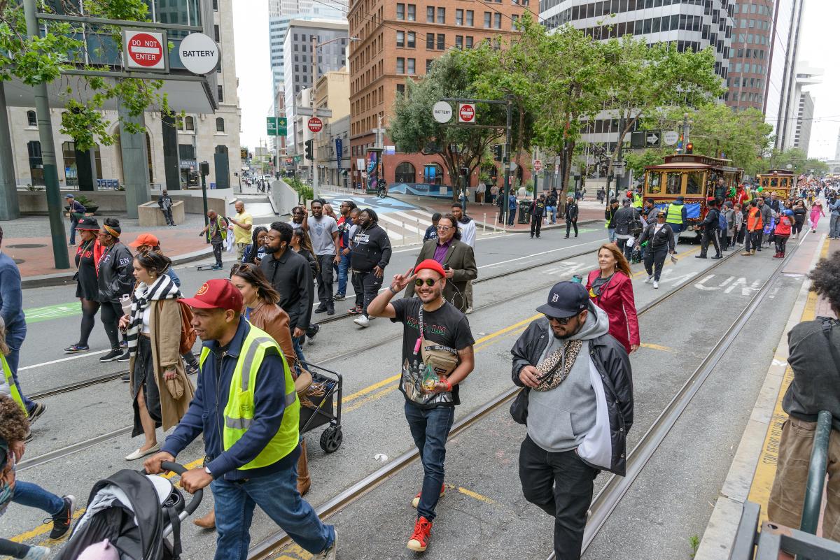 Crowd of people walking on Market Street as part of last year's Juneteenth Parade.