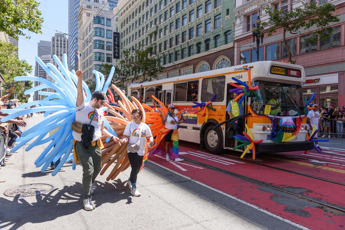 SFMTA contingent at last year's Pride Parade. People hold colorful balloon displays.