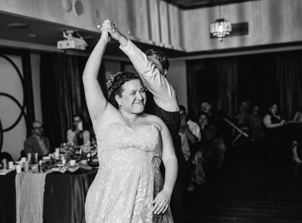 Black and white photo of Rogozen dancing at her wedding.