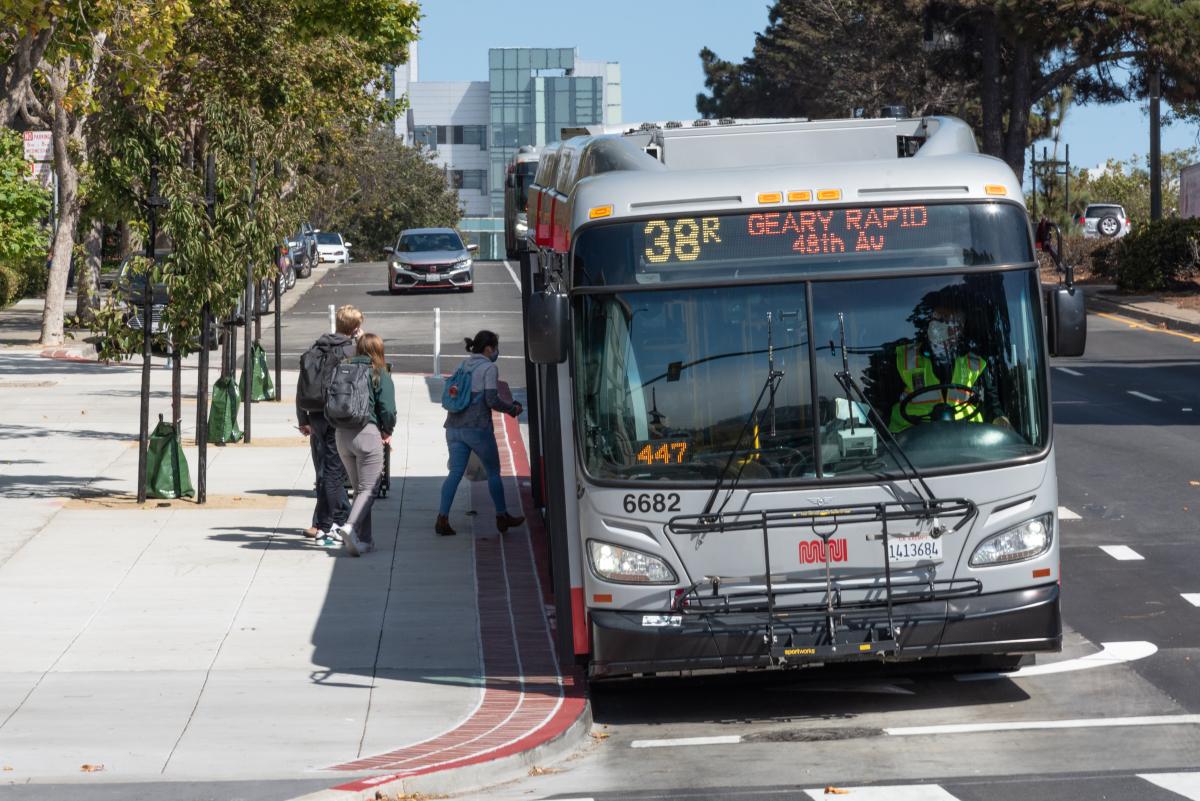 People board a 38R from a bus bulb, infrastructure that helps improve safety for people walking.
