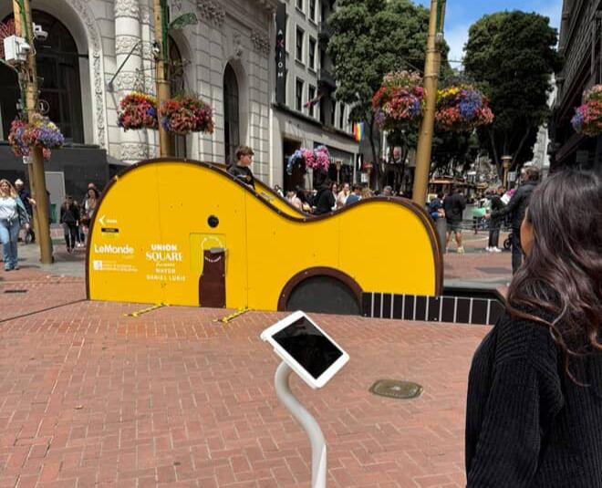 Art installation by the Powell cable car turnaround. It's a large yellow guitar that appears to sink into the ground.