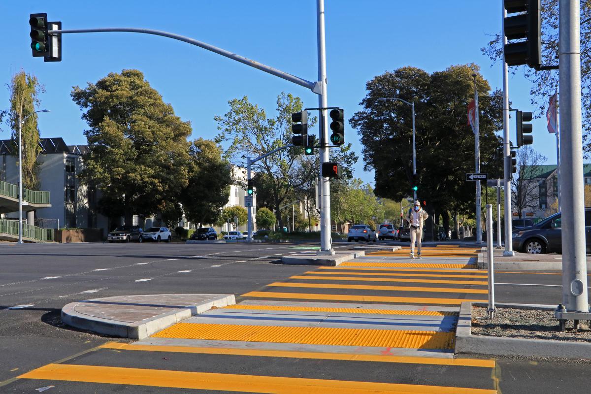 Bright yellow crosswalk on Geary with media refuges on one side. This infrastructure provides a safe place for people to wait if they can't finish crossing the street.