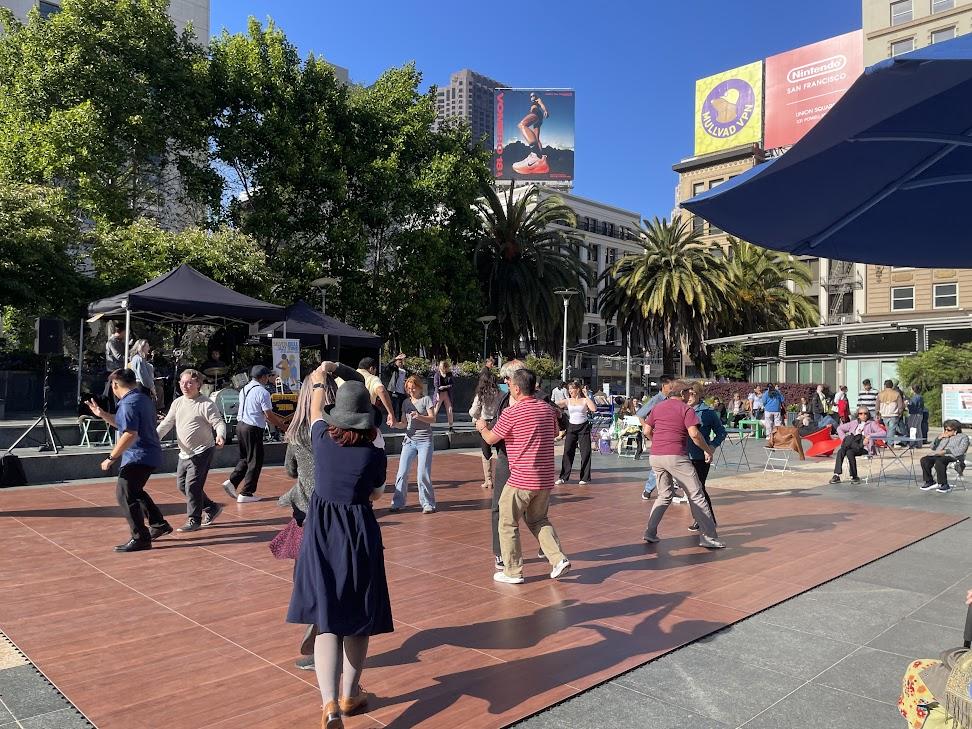 Group of people dancing in Union Square as part of free programming.