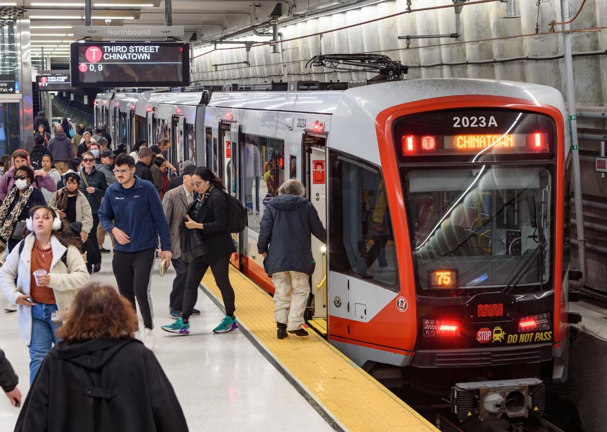 People exit and board a train at Union Square / Market Street Station.