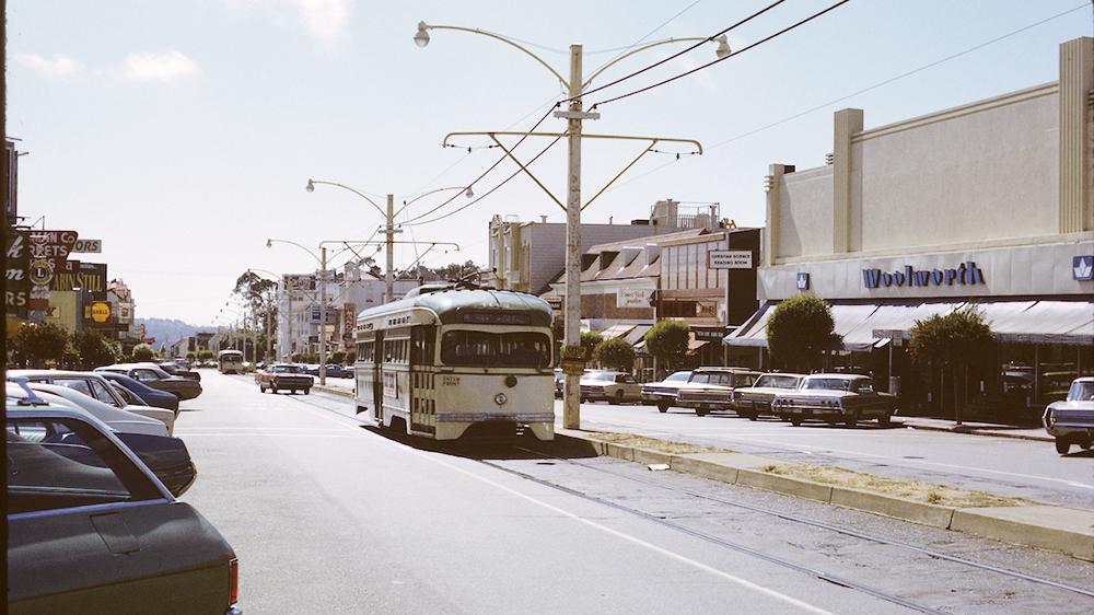 Vintage color photo dated 1972 of a historic streetcar on the M line driving down West Portal.
