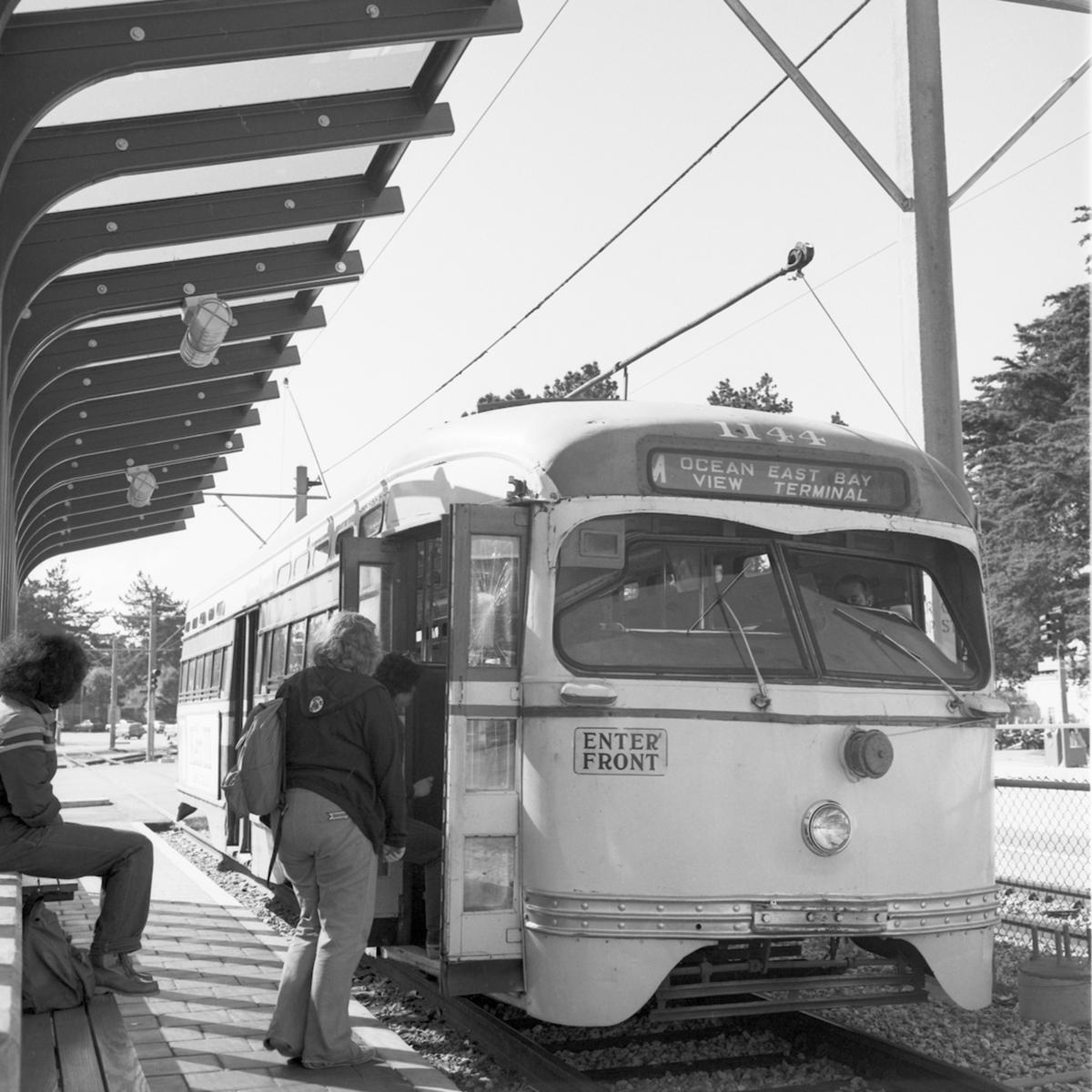 Black and white photo from 1979 of an M train picking up passengers near St. Francis Circle.