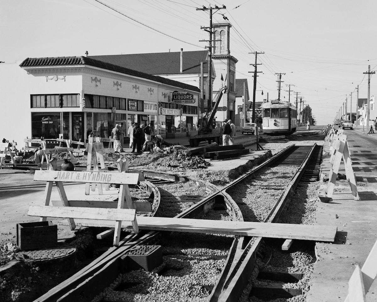 Black and white photo from 1957 showing construction on a track of the M line at Broad and Plymouth.