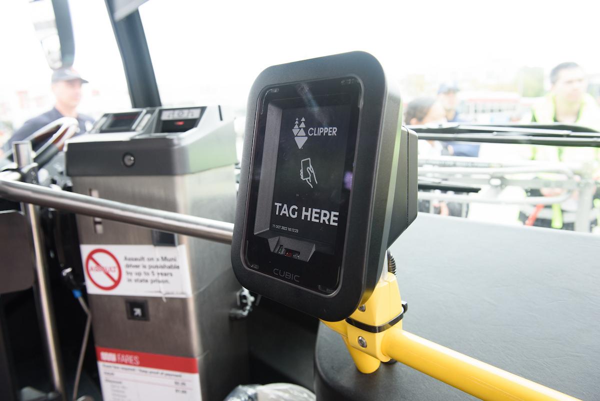 A machine attached to the dashboard of a bus.