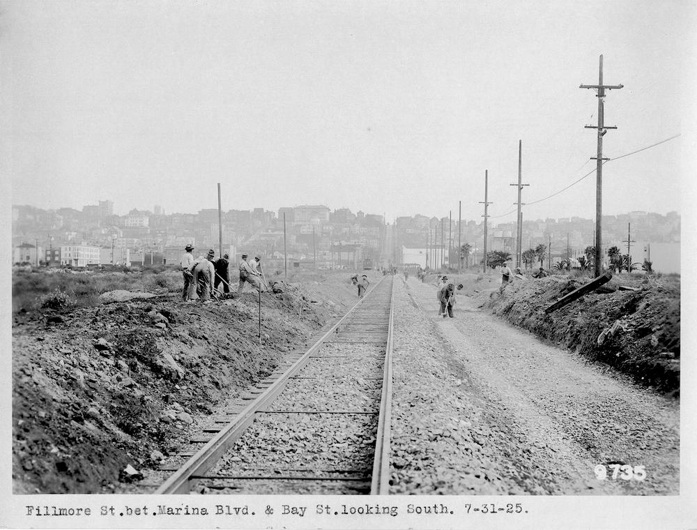 Black and white photo showing workers laying streetcar tracks for the 22 Fillmore.