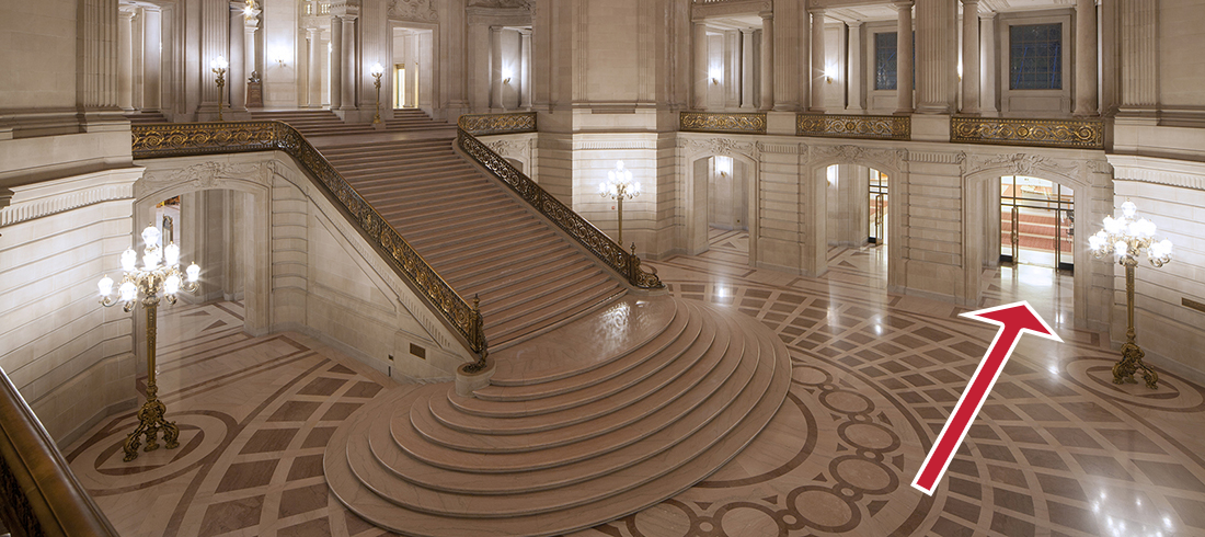 Arrow overlayed on picture of rotunda steps showing how to enter the north light court.