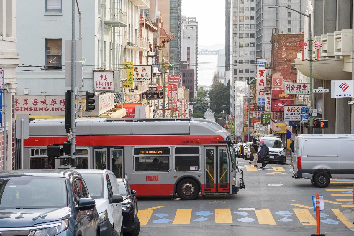 Muni bus passes through Chinatown. 