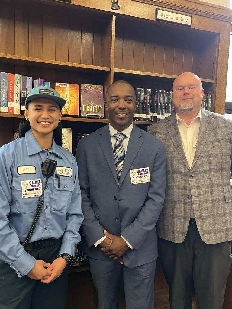 From left to right: Mechanic Jeena Villamor, Chief Mechanical Officer Michael Henry and Maintenance Operations Manager Austin Stenger smile for a photo in a library.