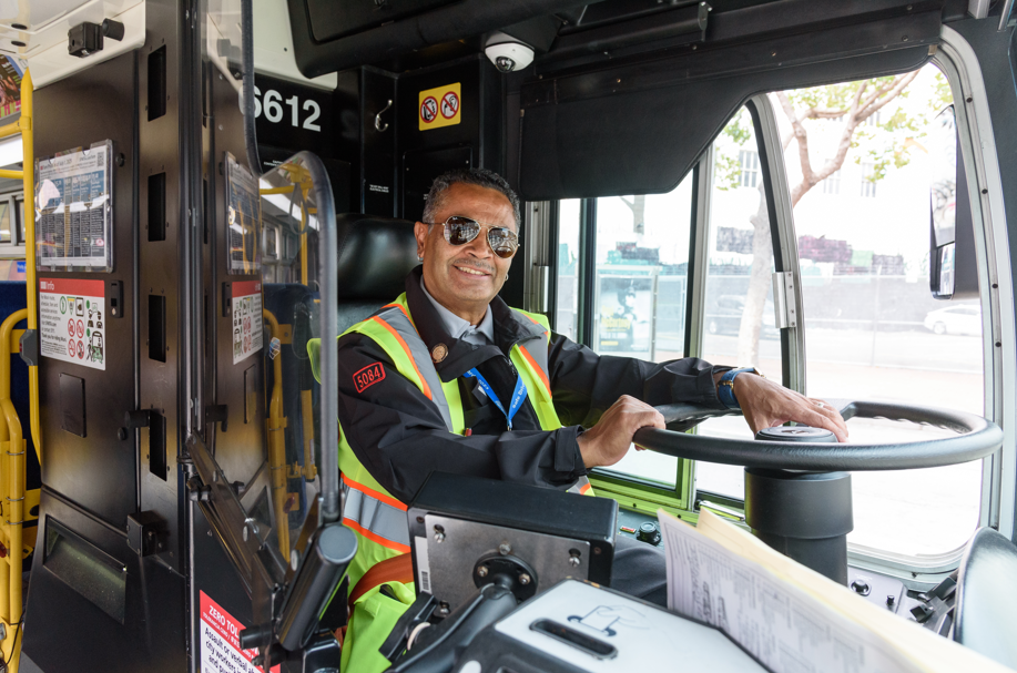 Bus operator smiles while driving