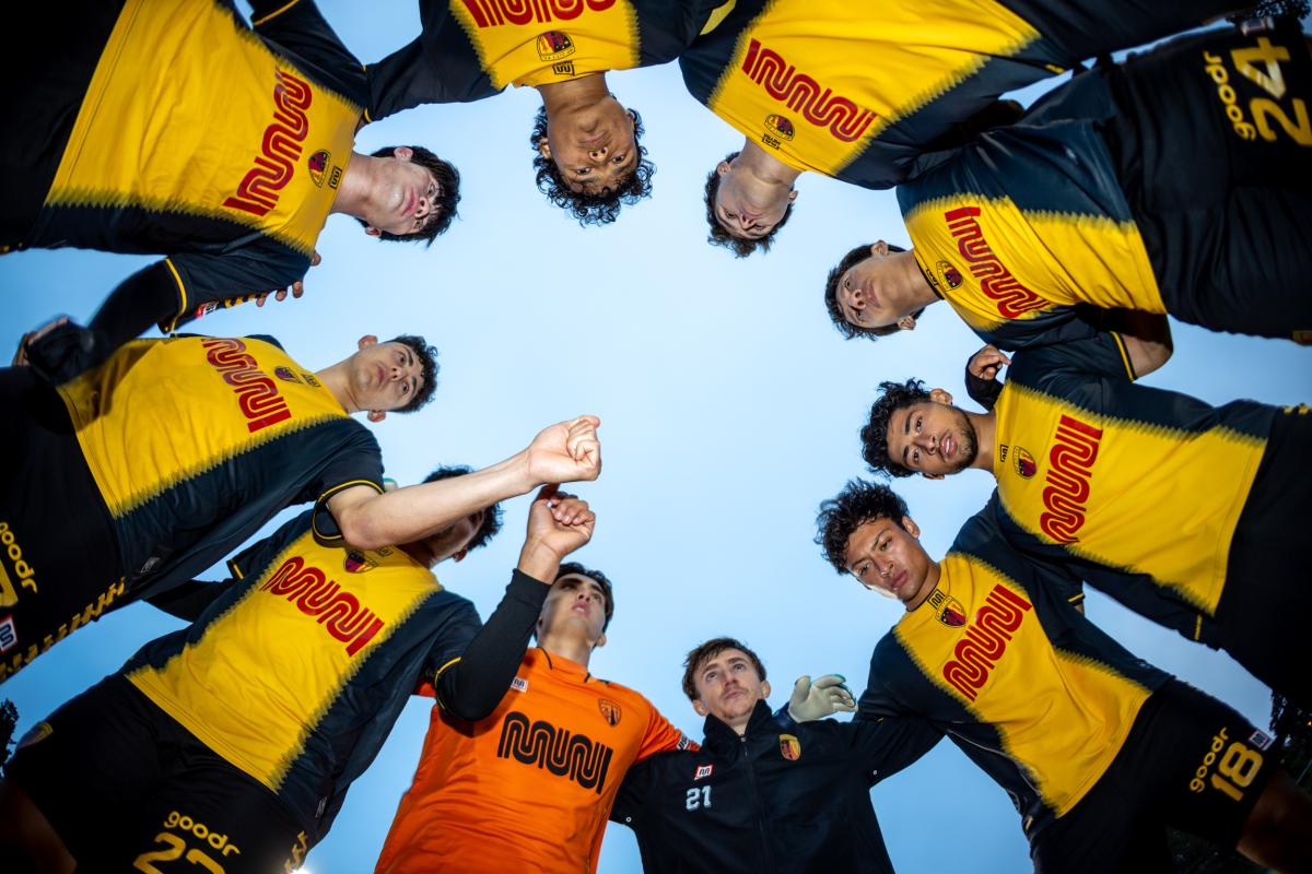 SF City Football Club players in Muni "worm" logo jerseys.