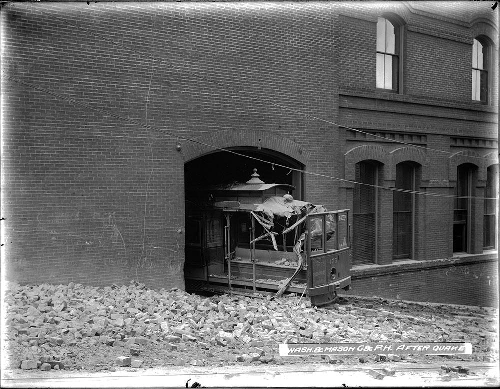 A damaged cable car surrounded by bricks.
