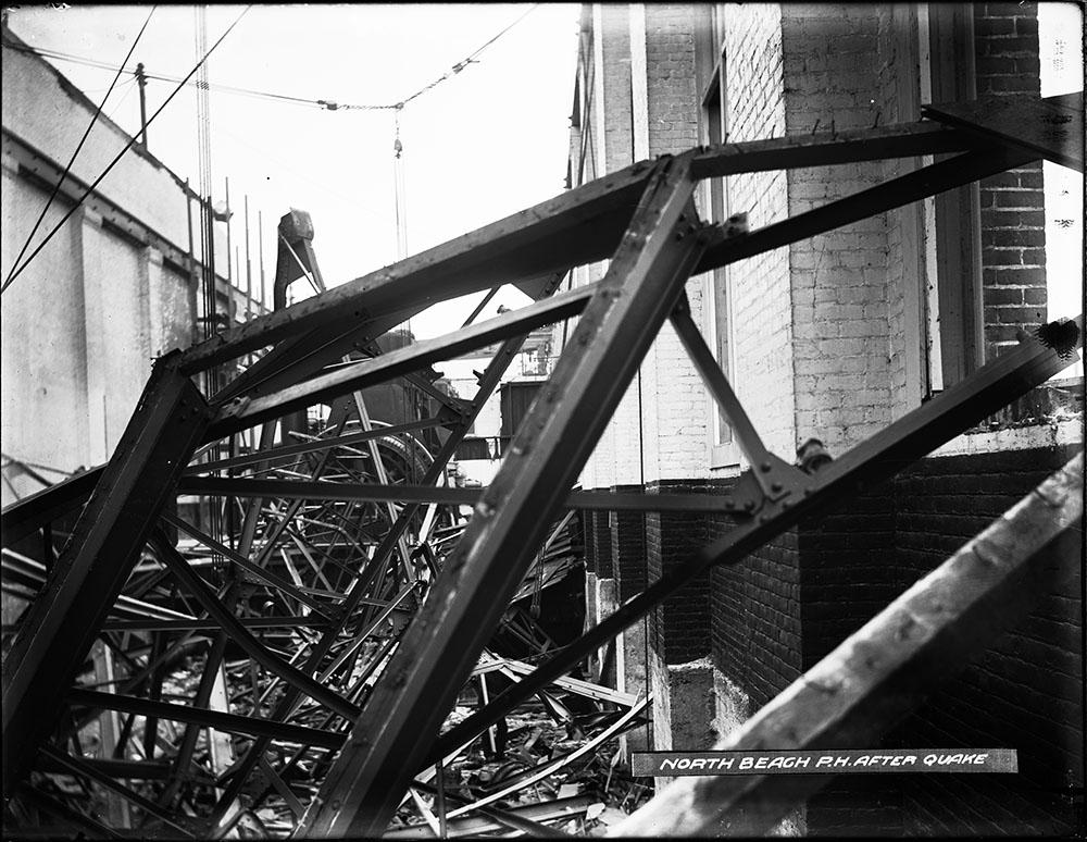 A tangle of steel and wood from the collapsed roof sits atop power generation machinery.