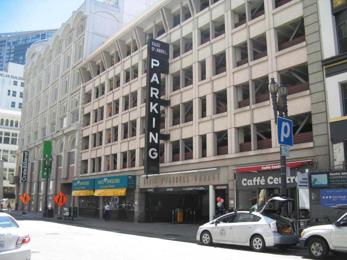 Multi level parking garage with cars parked on the street out front