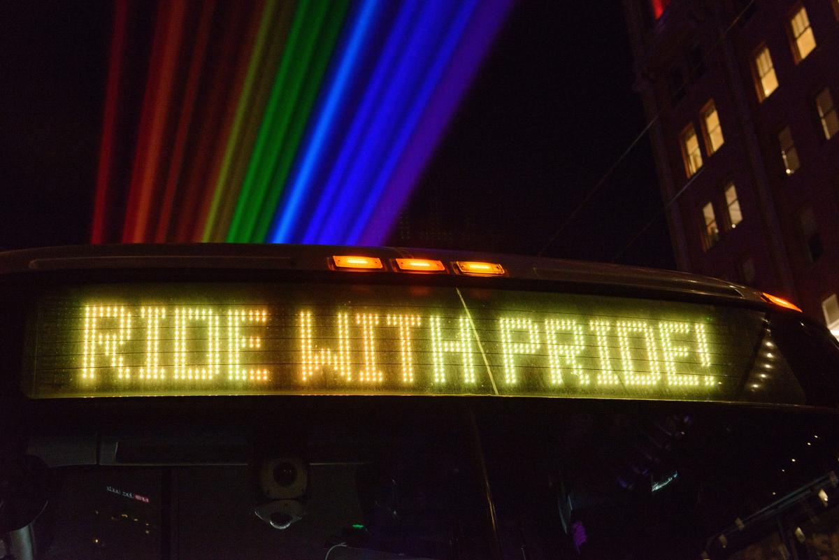 Digital letters on a bus that spell out “Ride with Pride.”