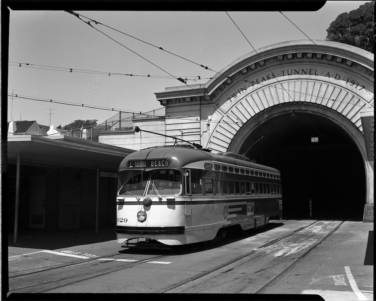 Black-and-white 1958 photo of an L Taraval streetcar emerging from the Twin Peaks Tunnel in San Francisco.