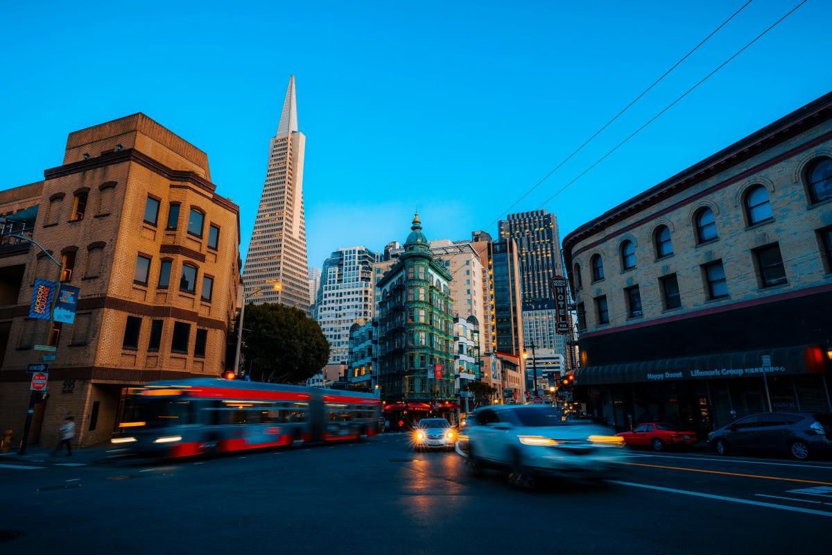 Buildings and a street with cars and a bus on it