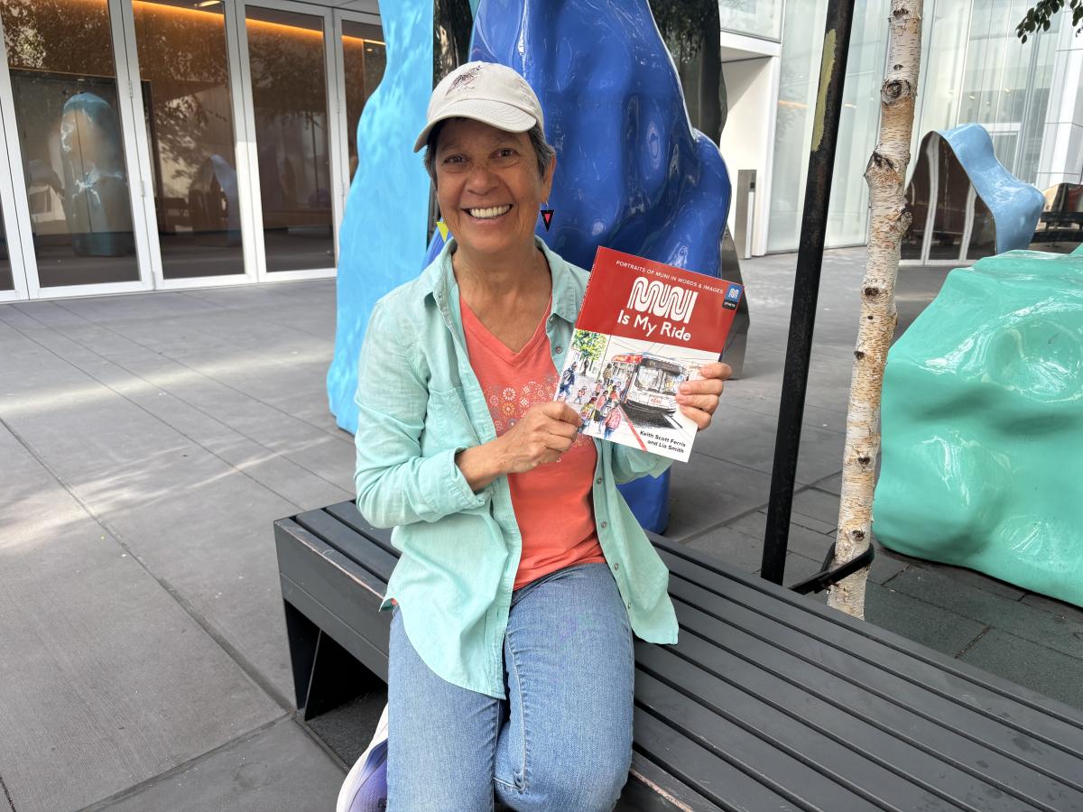 A woman sitting on a bench and holding a book