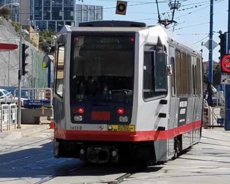 An N Judah Muni Metro train enters the subway portal at Duboce Avenue and Church Street.