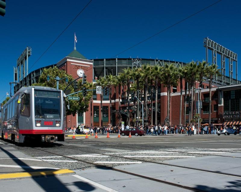 Muni light rail vehicle travels in front of AT&T Park.